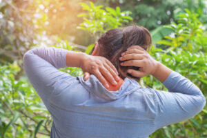 woman suffering from neck pain at outdoor