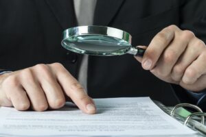 auditor examining files for employer workers' compensation fraud