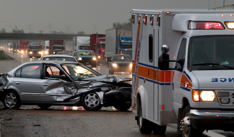 Image of a car accident with emergency personnel.